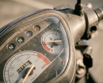 Close-up of motorcycle fuel gauge showing low fuel